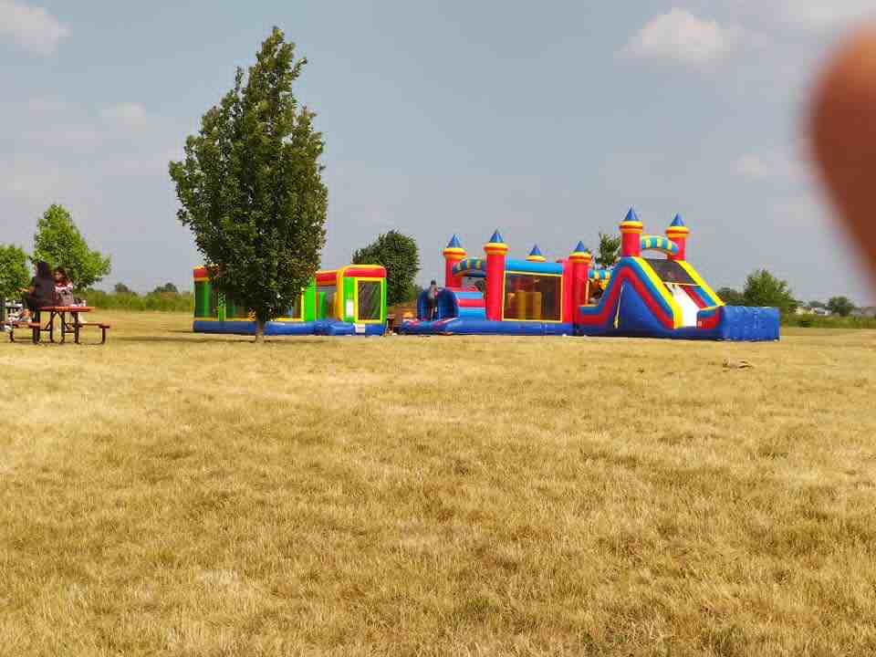 Multi-unit bounce house setup at outdoor event