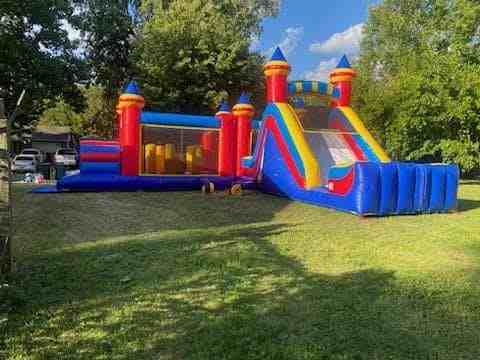 Backyard birthday with castle and slide combo